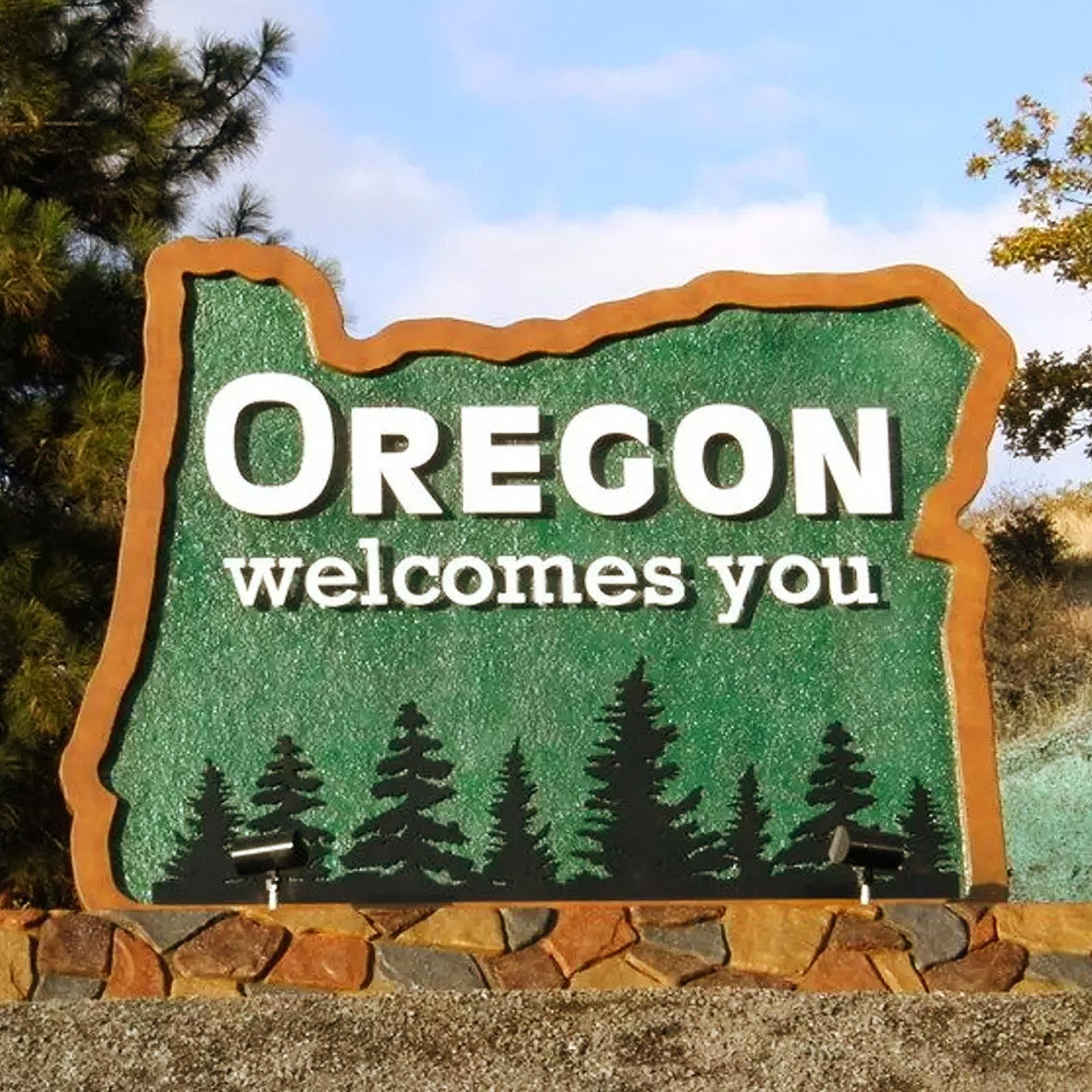 Sign in the shape of Oregon with the text ' Oregon welcomes you'