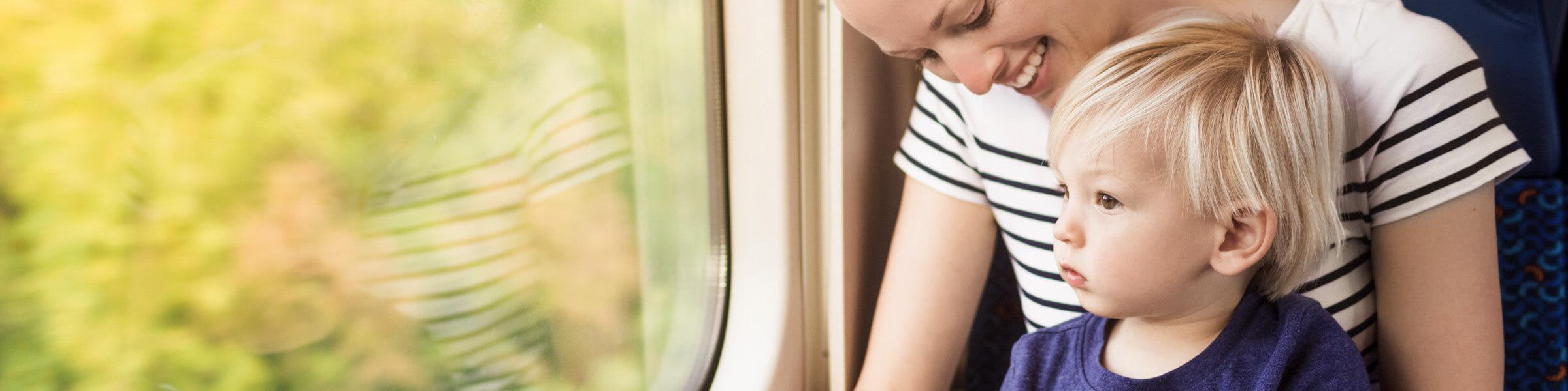 Woman and child looking out train window