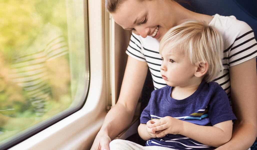 Woman and child looking out train window